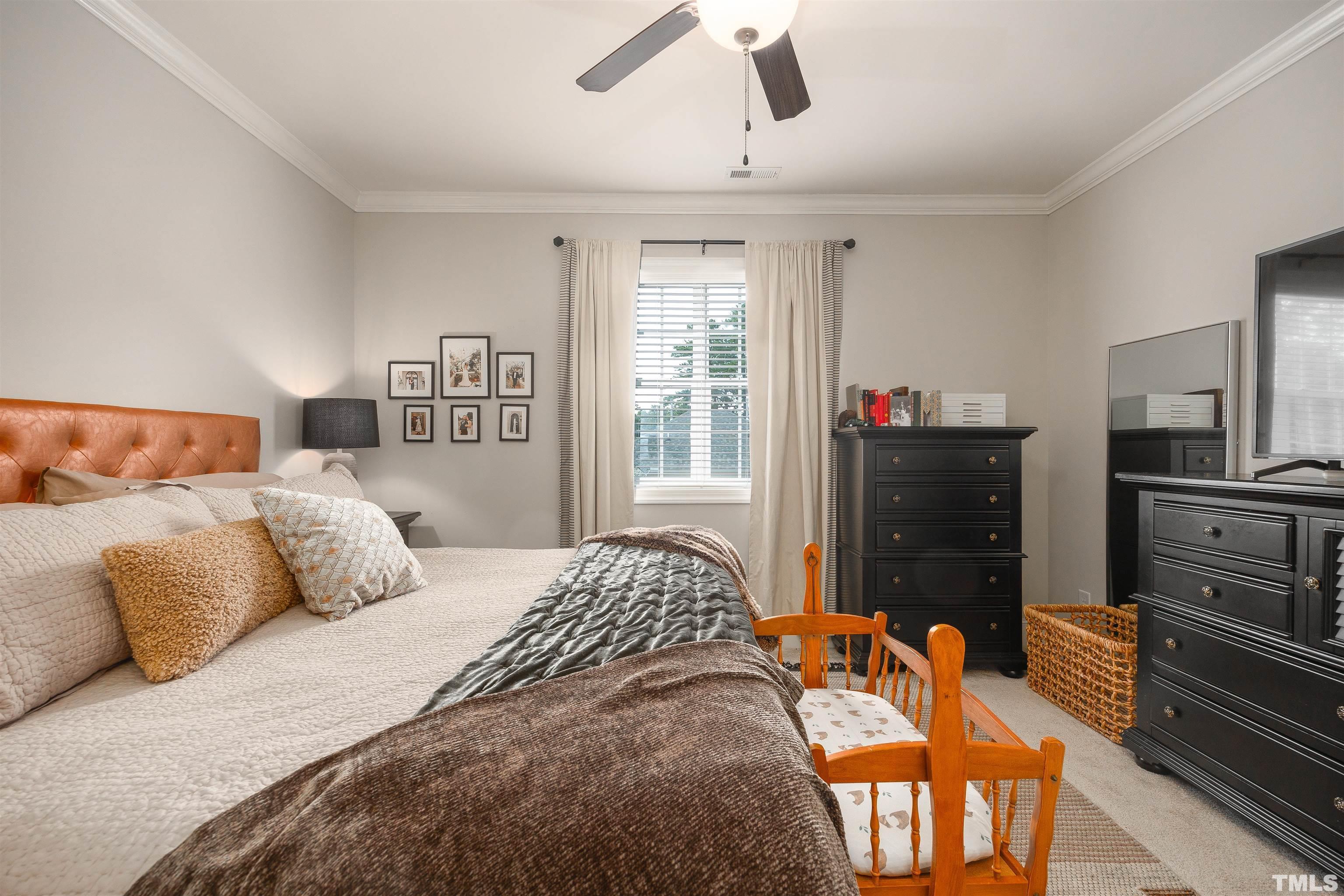 2829 Plumfield Place Raleigh, NC 27607 - Photo 17 of 26 a bedroom with a bed and wooden floor