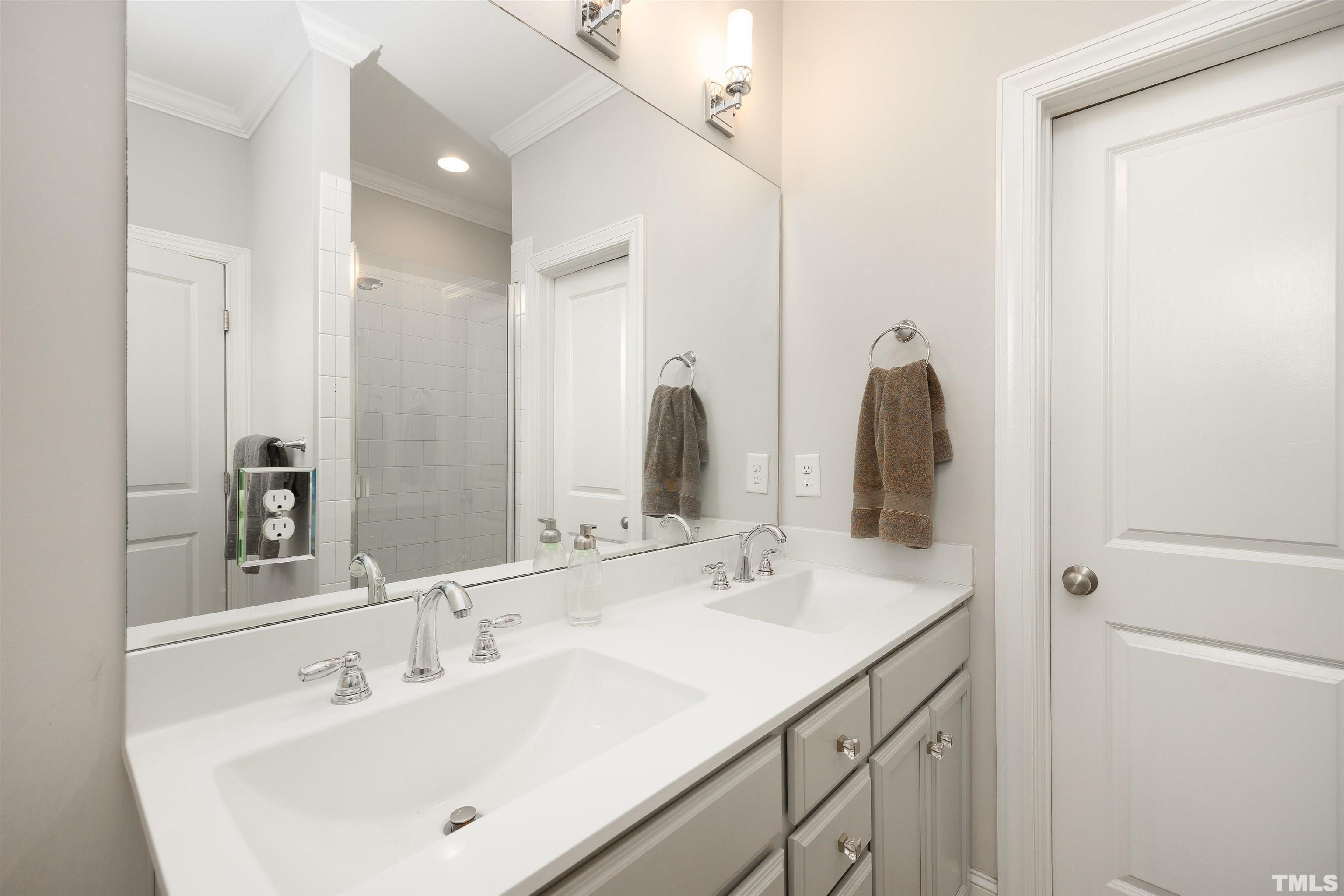 2829 Plumfield Place Raleigh, NC 27607 - Photo 19 of 26 a bathroom with a sink and a mirror