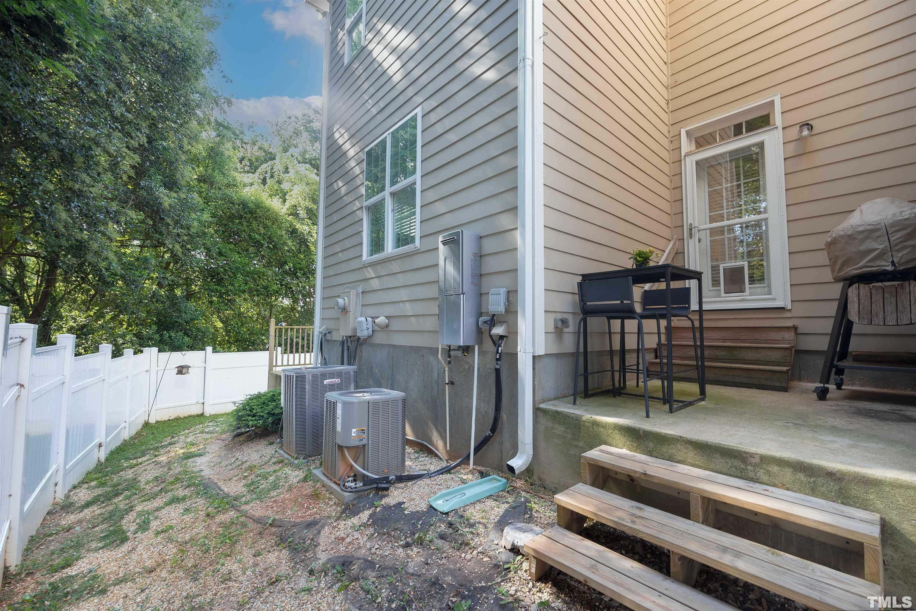 2829 Plumfield Place Raleigh, NC 27607 - Photo 24 of 26 a view of a backyard with chairs and a large tree