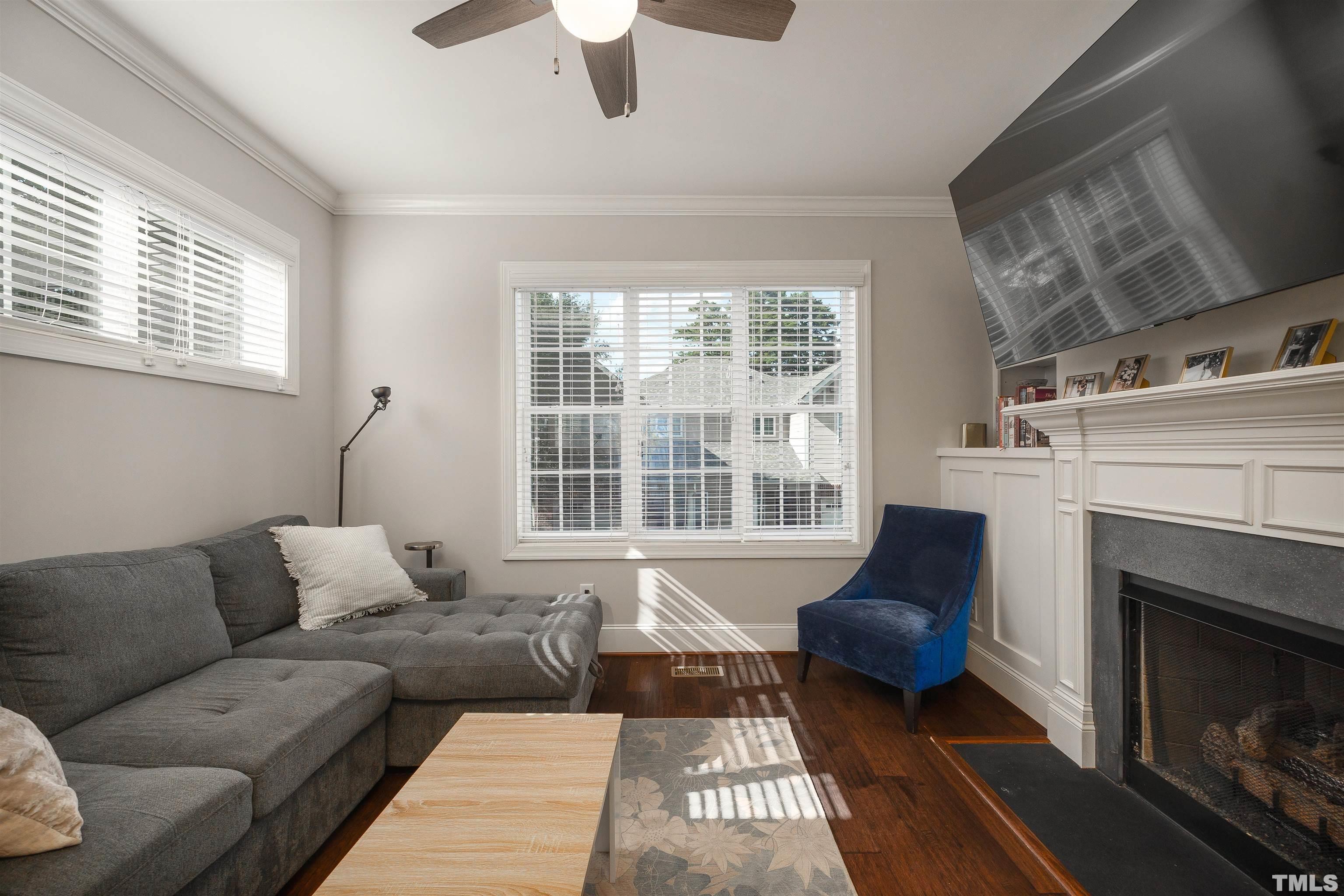 2829 Plumfield Place Raleigh, NC 27607 - Photo 3 of 26 a living room with furniture and a fireplace