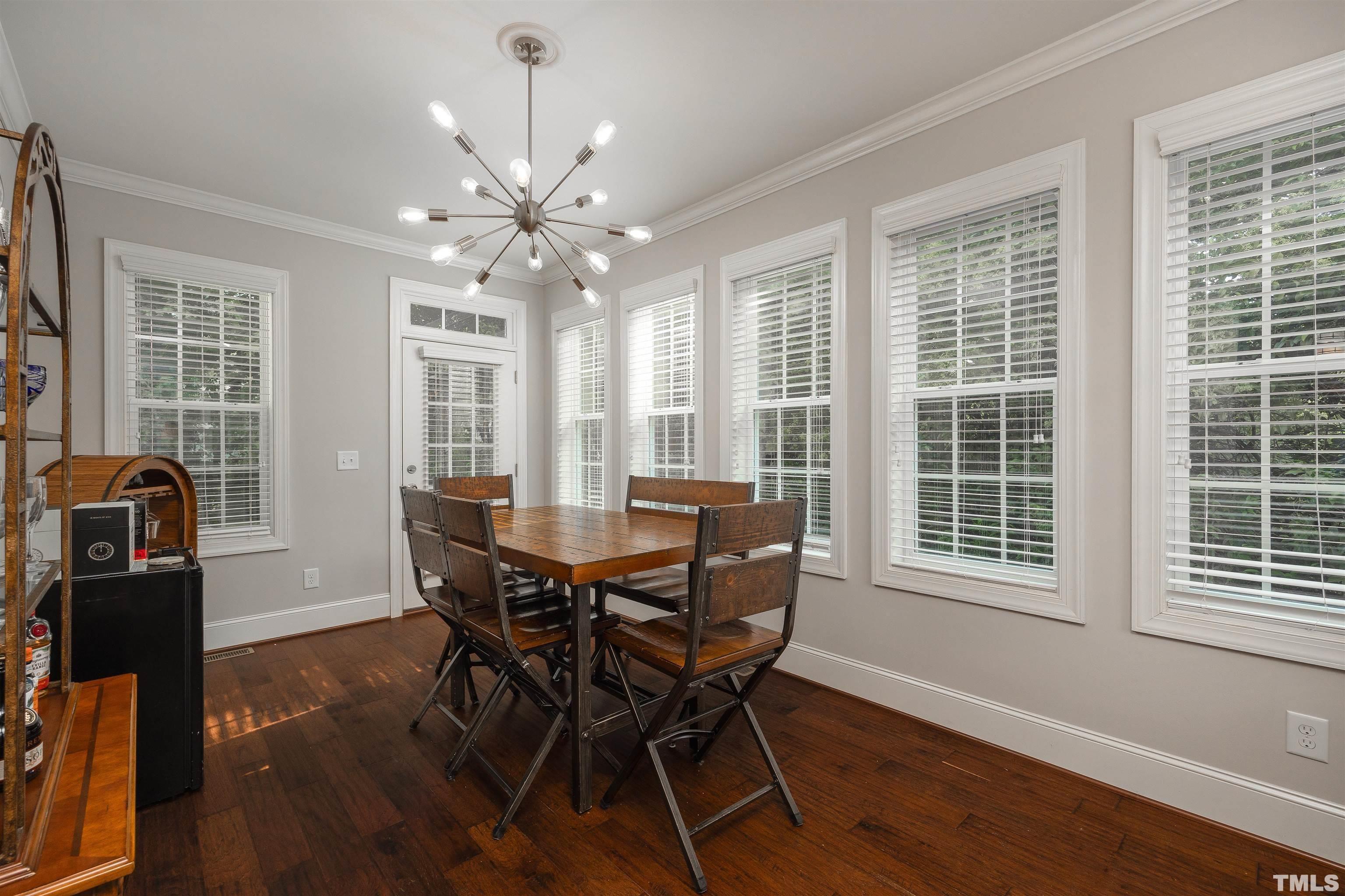 2829 Plumfield Place Raleigh, NC 27607 - Photo 8 of 26 a view of a dining room with furniture window and wooden floor