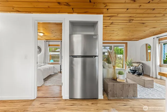 a view of kitchen with furniture and refrigerator