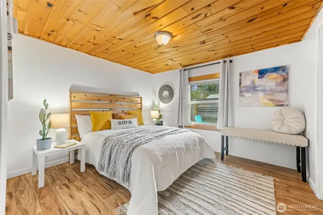 a bedroom with a bed and a large window with outer view