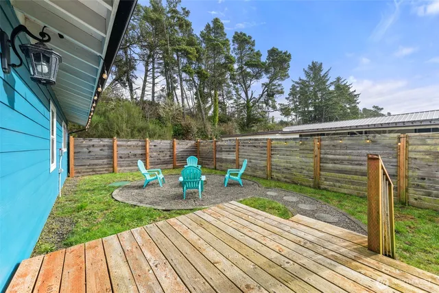 a view of a chair and table on the wooden deck