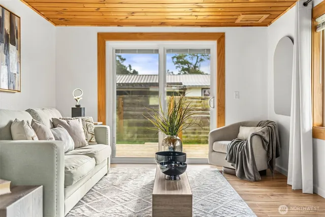 a living room with furniture and a floor to ceiling window