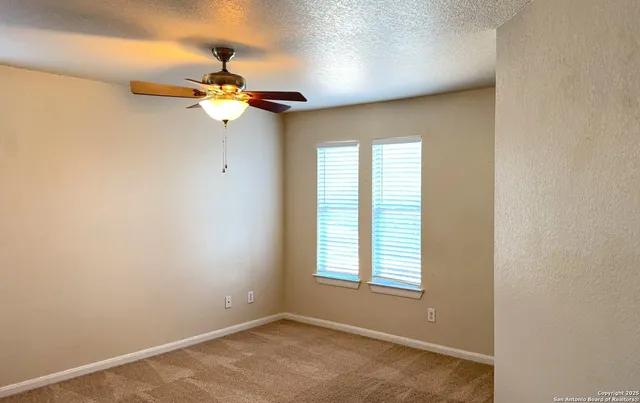 a view of a chandelier fan and a window