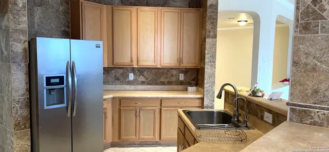 a kitchen with a refrigerator and a sink