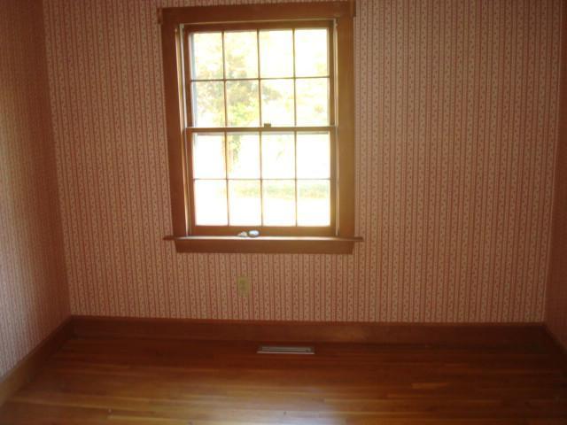 1318 County Road Cataumet, MA 02534 - Photo 5 of 7 an empty room with wooden floor and windows