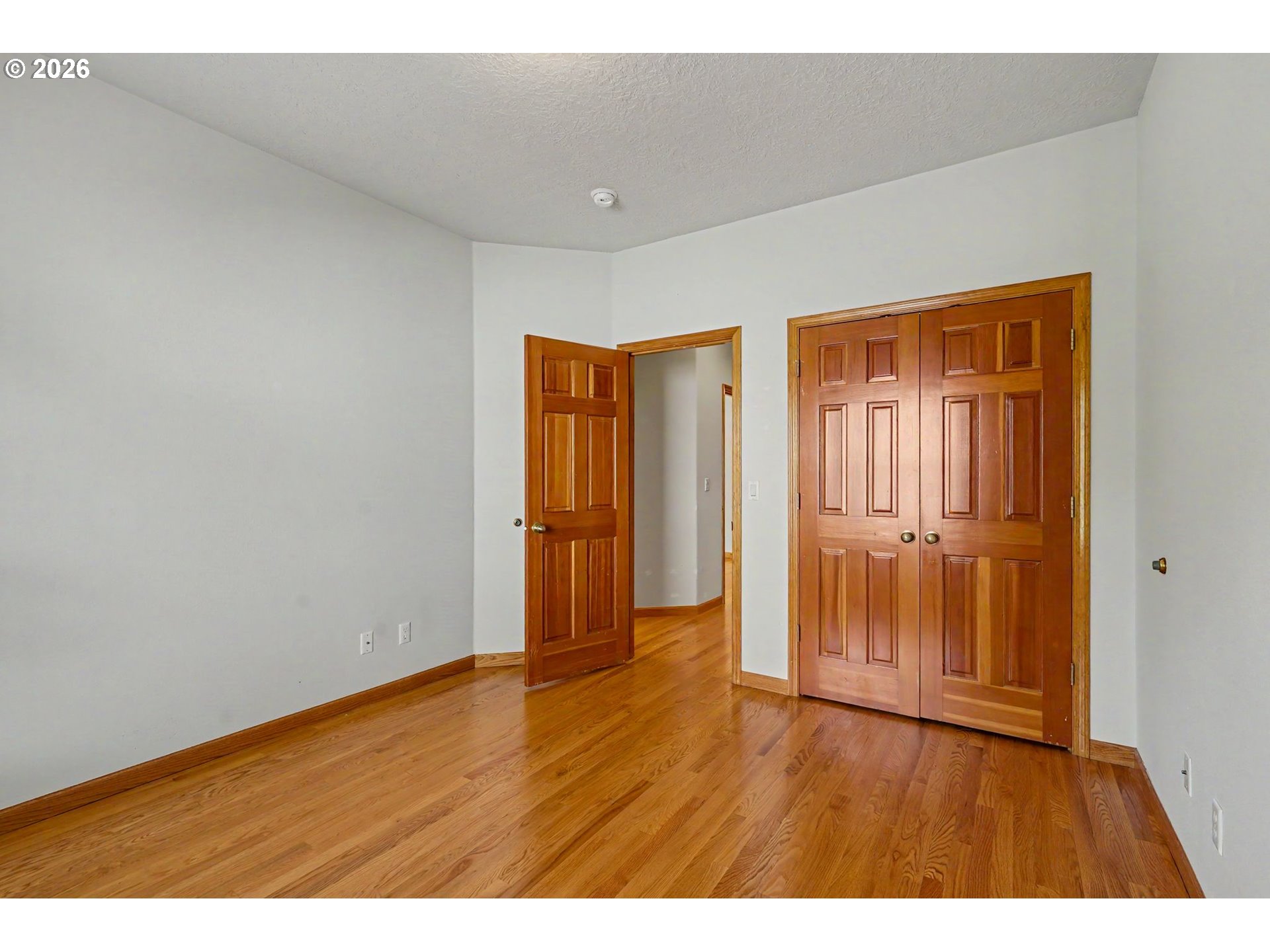1470 Ranier Loop Northwest Salem, OR 97304 - Photo 40 of 48 a view of an empty room with wooden floor