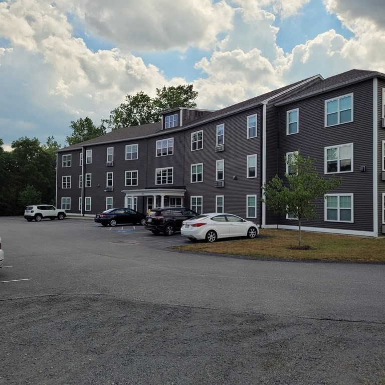 130 Spring Street, Unit 202 Mansfield, MA 02048 - Photo 1 of 23 a view of street with parked cars