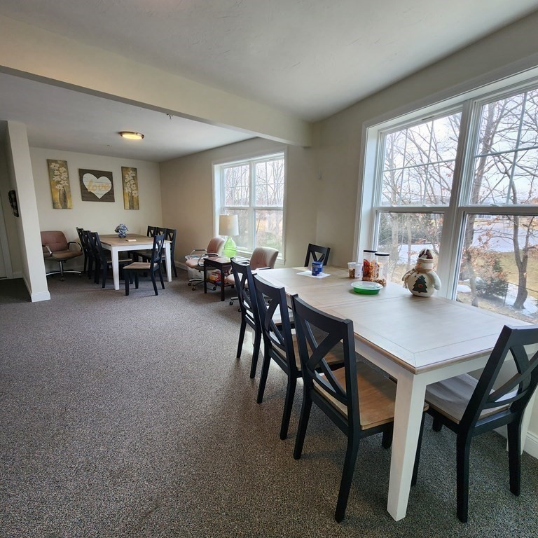 130 Spring Street, Unit 202 Mansfield, MA 02048 - Photo 18 of 23 a view of a dining room with furniture and a large window