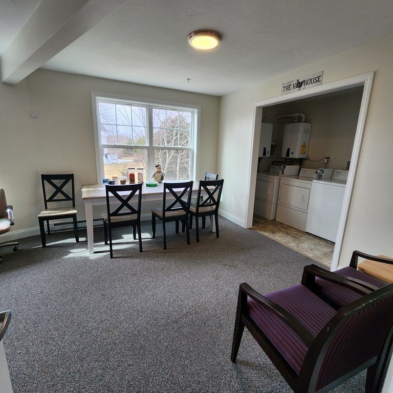130 Spring Street, Unit 202 Mansfield, MA 02048 - Photo 19 of 23 a living room with furniture and a flat screen tv