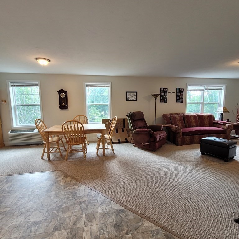 130 Spring Street, Unit 202 Mansfield, MA 02048 - Photo 5 of 23 a living room with furniture and a large window