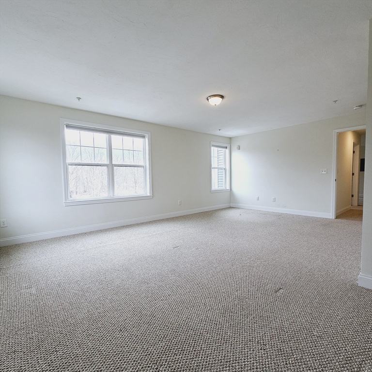 130 Spring Street, Unit 202 Mansfield, MA 02048 - Photo 7 of 23 an empty room with windows