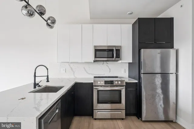 a kitchen with a sink a stove and refrigerator
