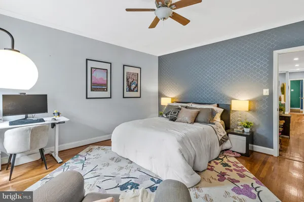 a bedroom with a bed and a desk