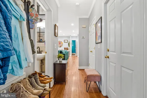 a view of a hallway with furniture and wooden floor