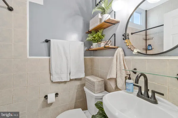 a bathroom with a toilet sink and mirror