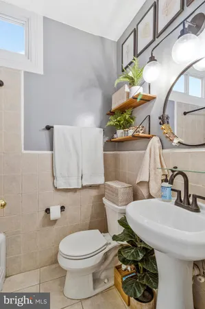 a bathroom with a sink toilet and mirror