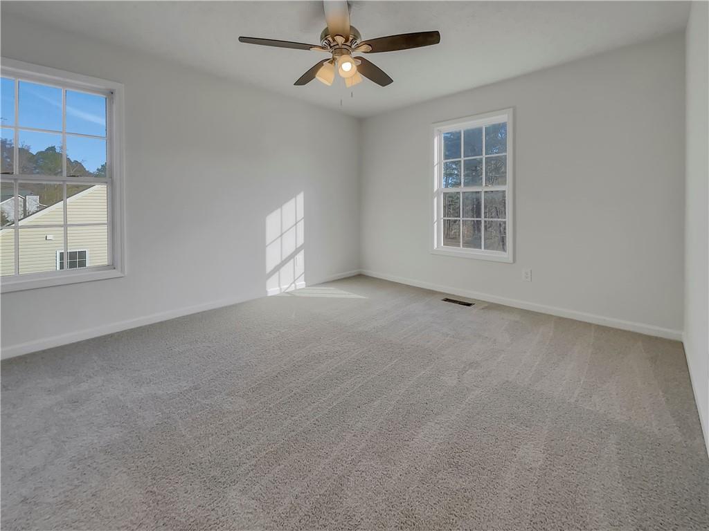 35 Grove Lane Temple, GA 30179 - Photo 13 of 25 an empty room with windows and chandelier fan
