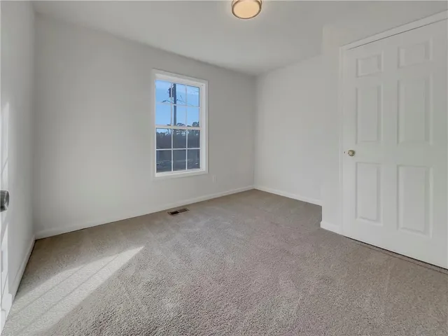 a view of a livingroom with an empty space and window