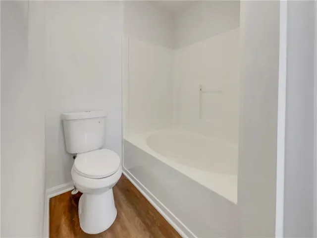 a bathroom with a toilet and a bathtub