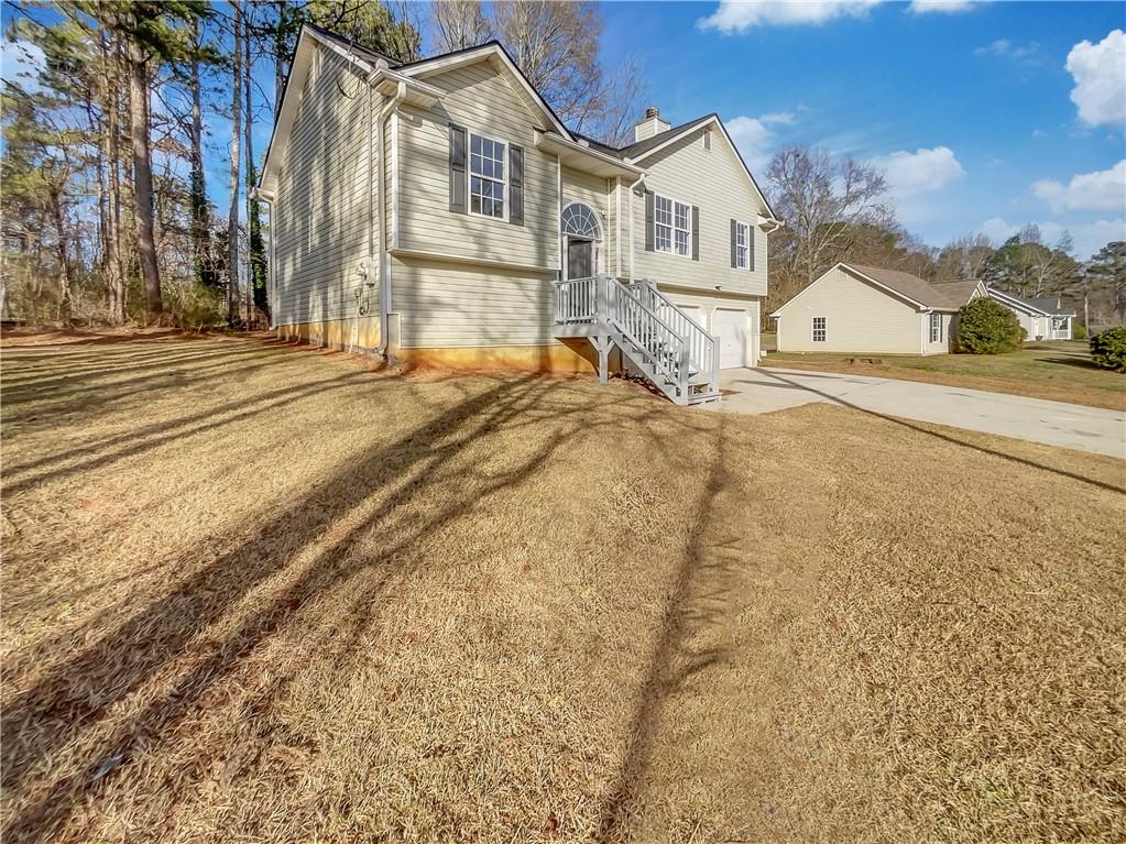 35 Grove Lane Temple, GA 30179 - Photo 2 of 25 a view of a white house with a large trees next to a road