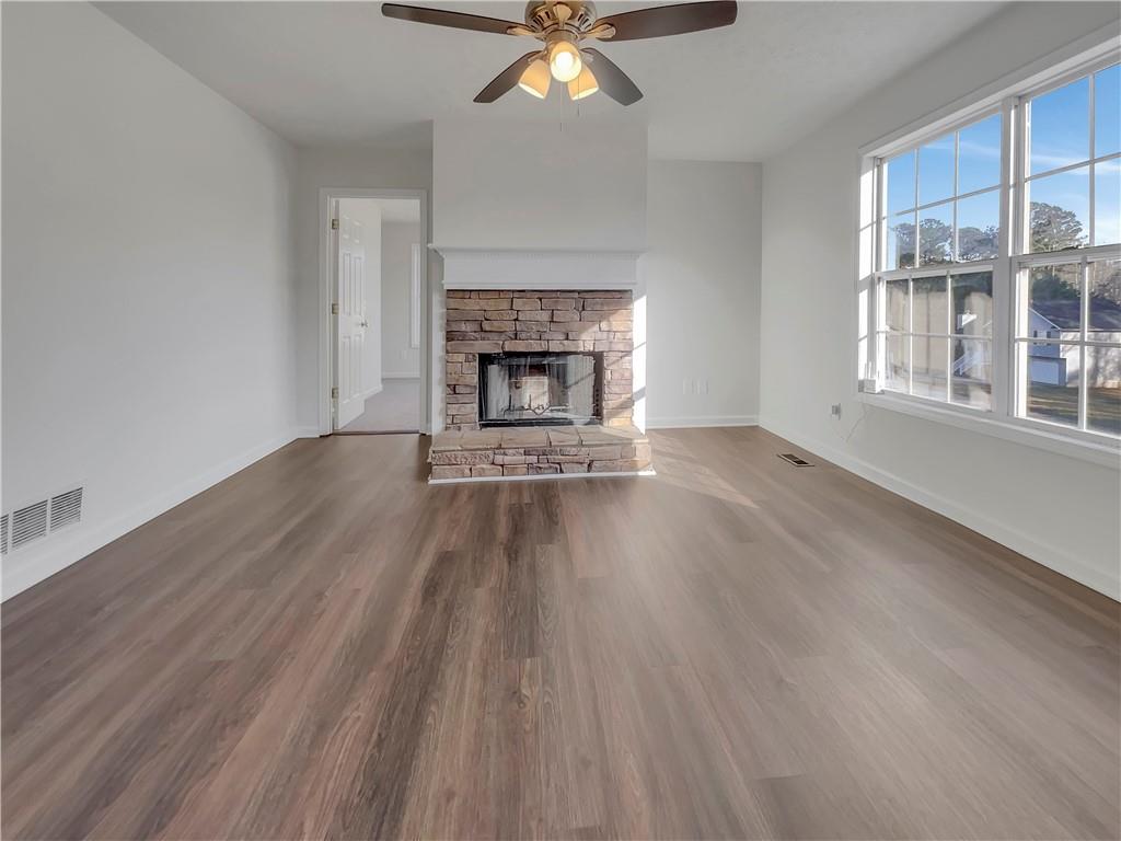 35 Grove Lane Temple, GA 30179 - Photo 6 of 25 a view of an empty room with wooden floor fireplace and a window