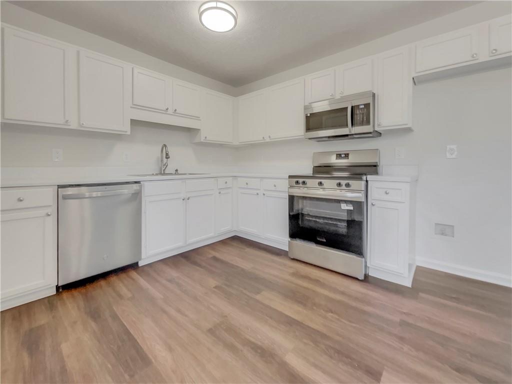 35 Grove Lane Temple, GA 30179 - Photo 8 of 25 a kitchen with stainless steel appliances granite countertop a stove a sink and a microwave