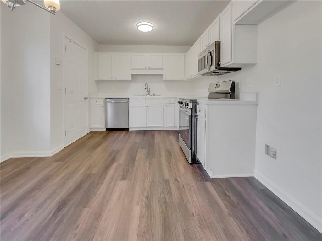 35 Grove Lane Temple, GA 30179 - Photo 9 of 25 a kitchen with cabinets a sink and wooden floor