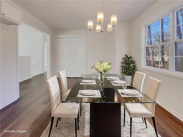 a view of a dining room with furniture wooden floor and a chandelier