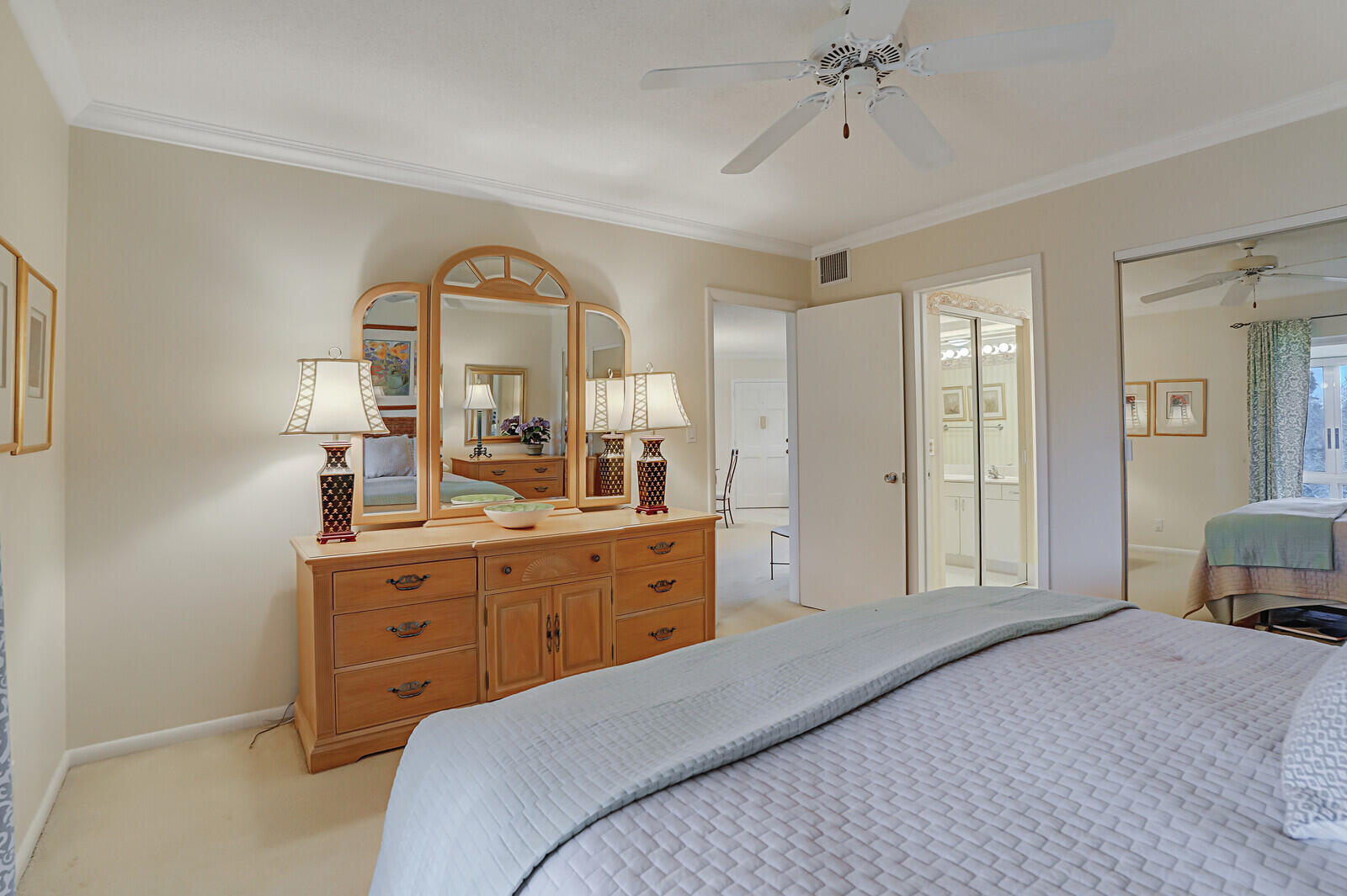 20 Celestial Way, Unit 314 Juno Beach, FL 33408 - Photo 17 of 35 a bedroom with a bed and a chandelier