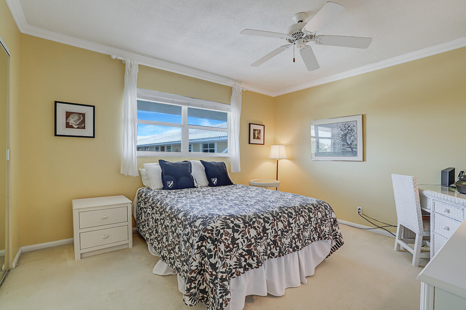 20 Celestial Way, Unit 314 Juno Beach, FL 33408 - Photo 19 of 35 a bedroom with a bed and a chandelier