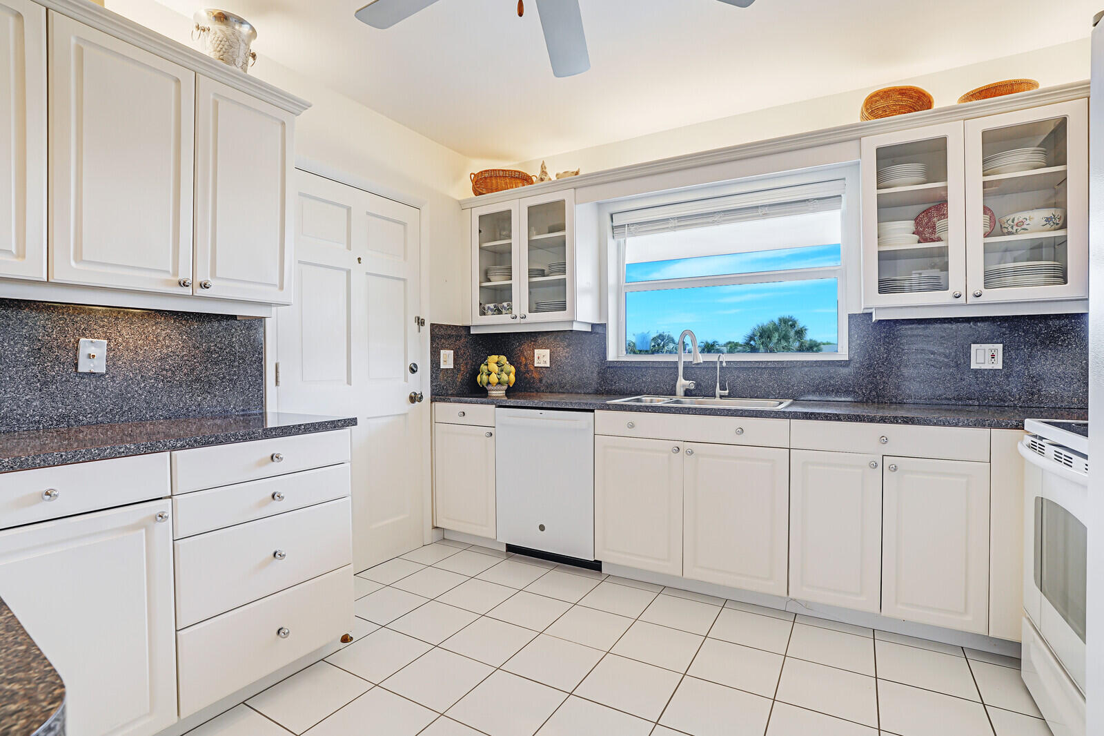20 Celestial Way, Unit 314 Juno Beach, FL 33408 - Photo 6 of 35 a kitchen with stainless steel appliances granite countertop white cabinets and window
