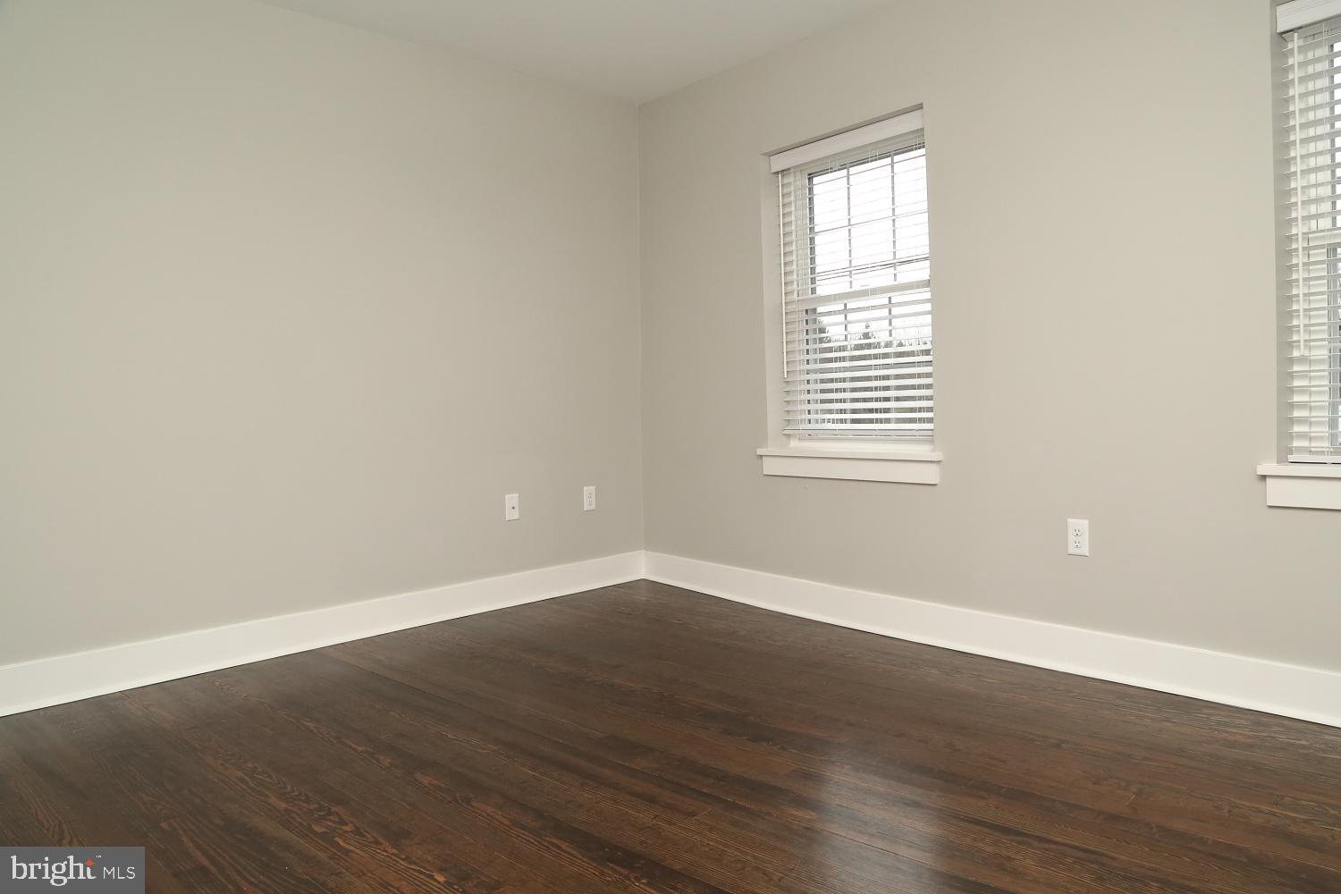 2 South Lime Street, Unit 6 Quarryville, PA 17566 - Photo 8 of 9 an empty room with wooden floor and windows