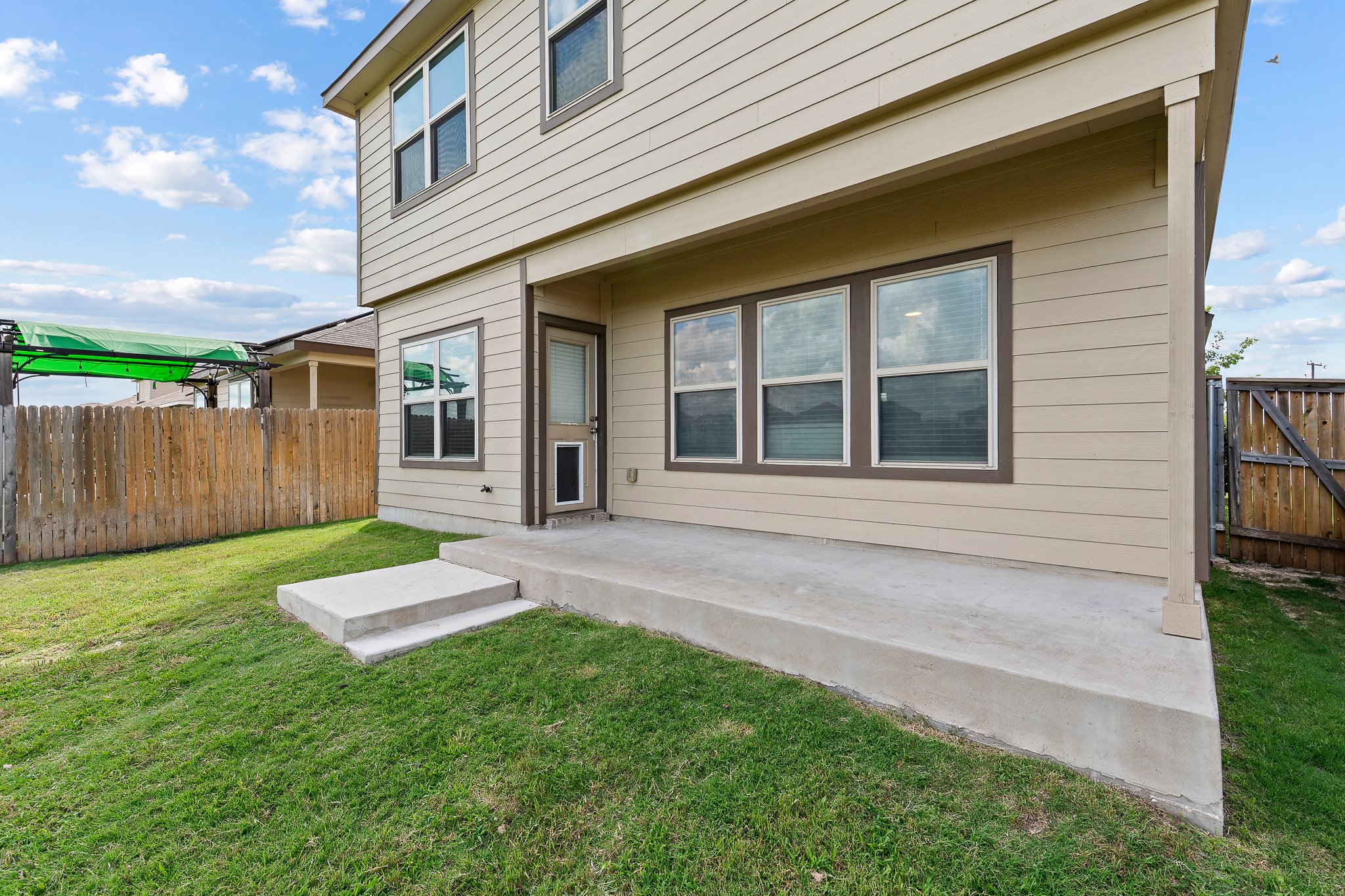 576 Greatest Gift Way Jarrell, TX 76537 - Photo 30 of 37 A private, fenced backyard offers a concrete patio for outdoor enjoyment.