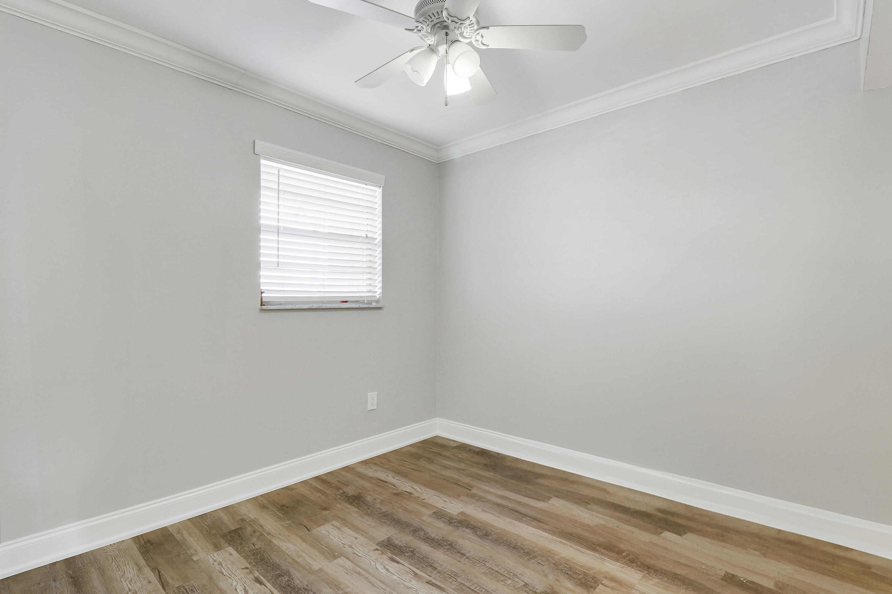 2600 South Kanner Highway, Unit Q8 Stuart, FL 34994 - Photo 12 of 52 an empty room with a window and a fan