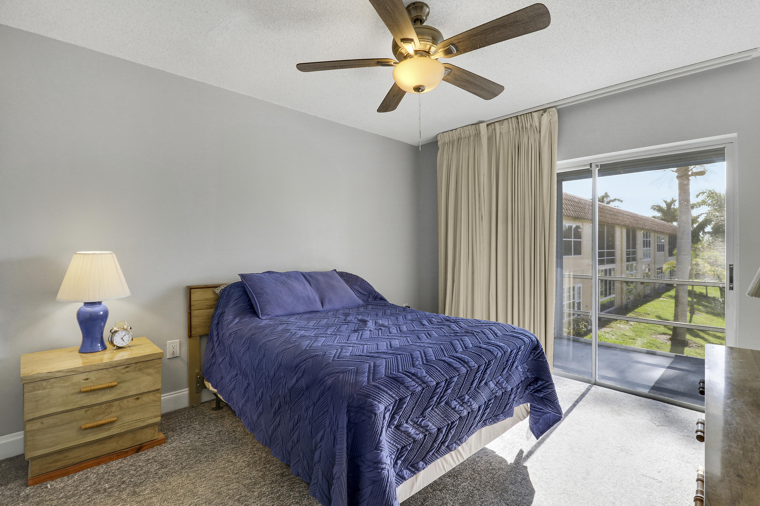 2600 South Kanner Highway, Unit Q8 Stuart, FL 34994 - Photo 17 of 52 a bedroom with a bed a chandelier and a window