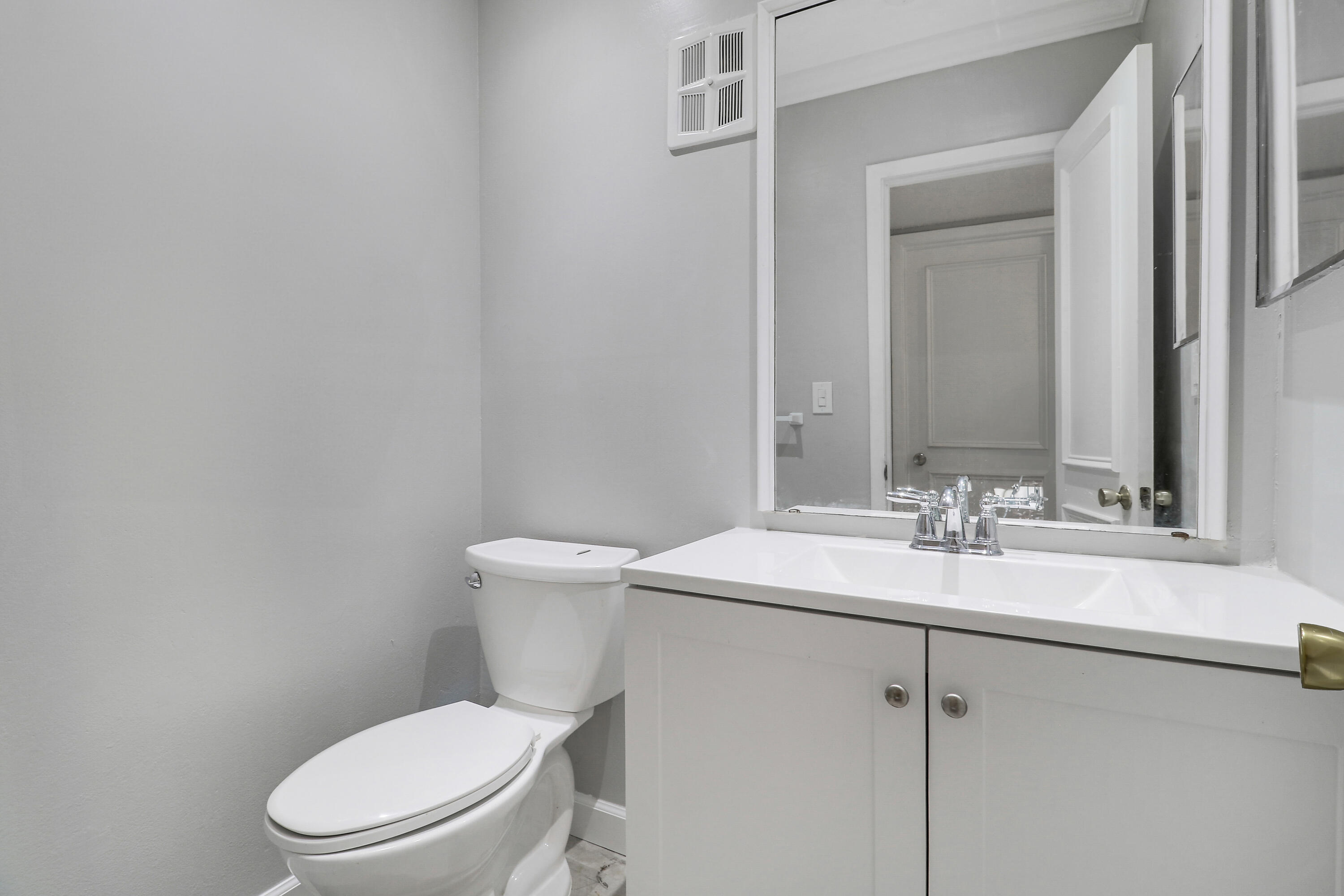 2600 South Kanner Highway, Unit Q8 Stuart, FL 34994 - Photo 24 of 52 a white toilet sitting next to a bathroom sink