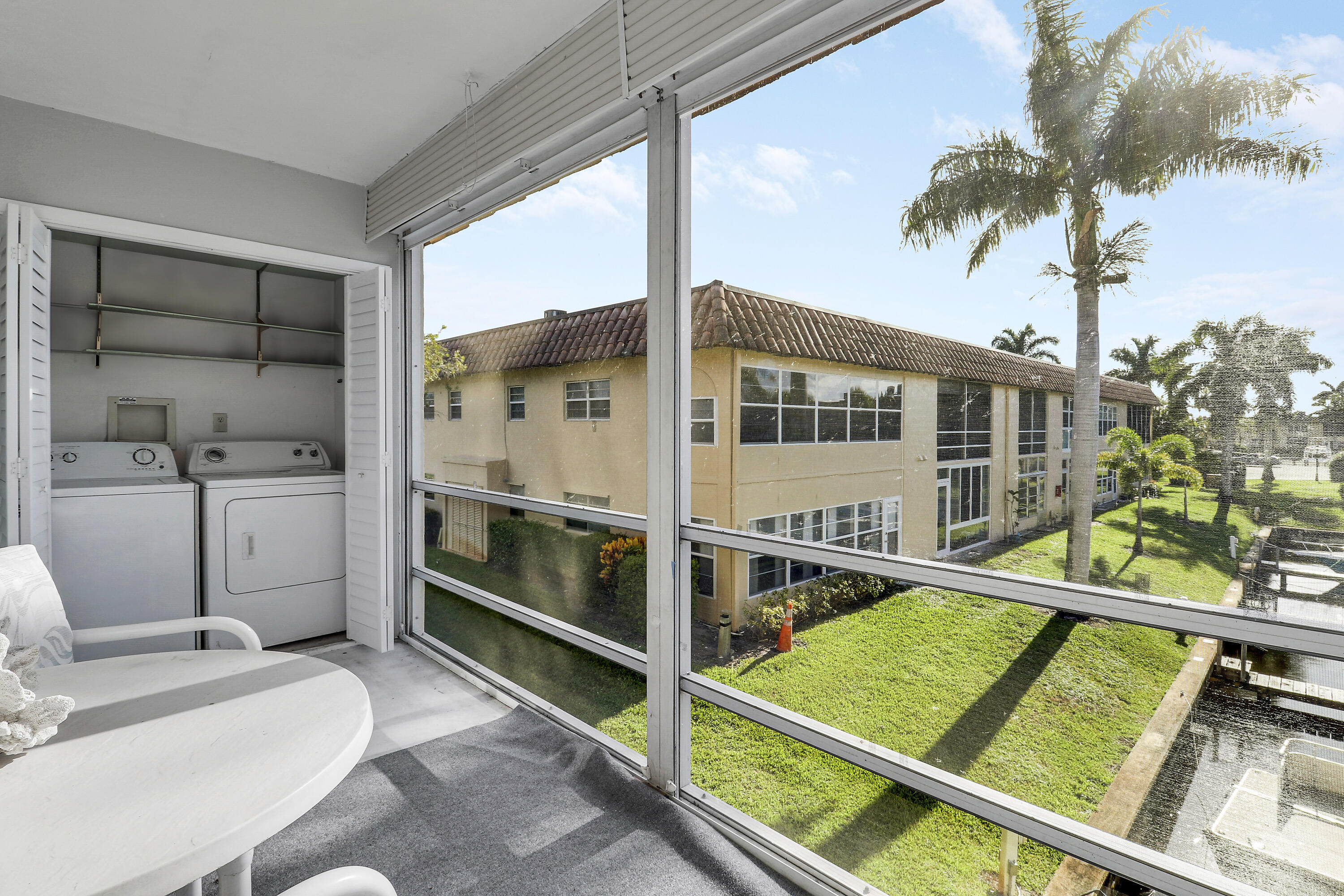 2600 South Kanner Highway, Unit Q8 Stuart, FL 34994 - Photo 27 of 52 a view of balcony with a large window and palm tree