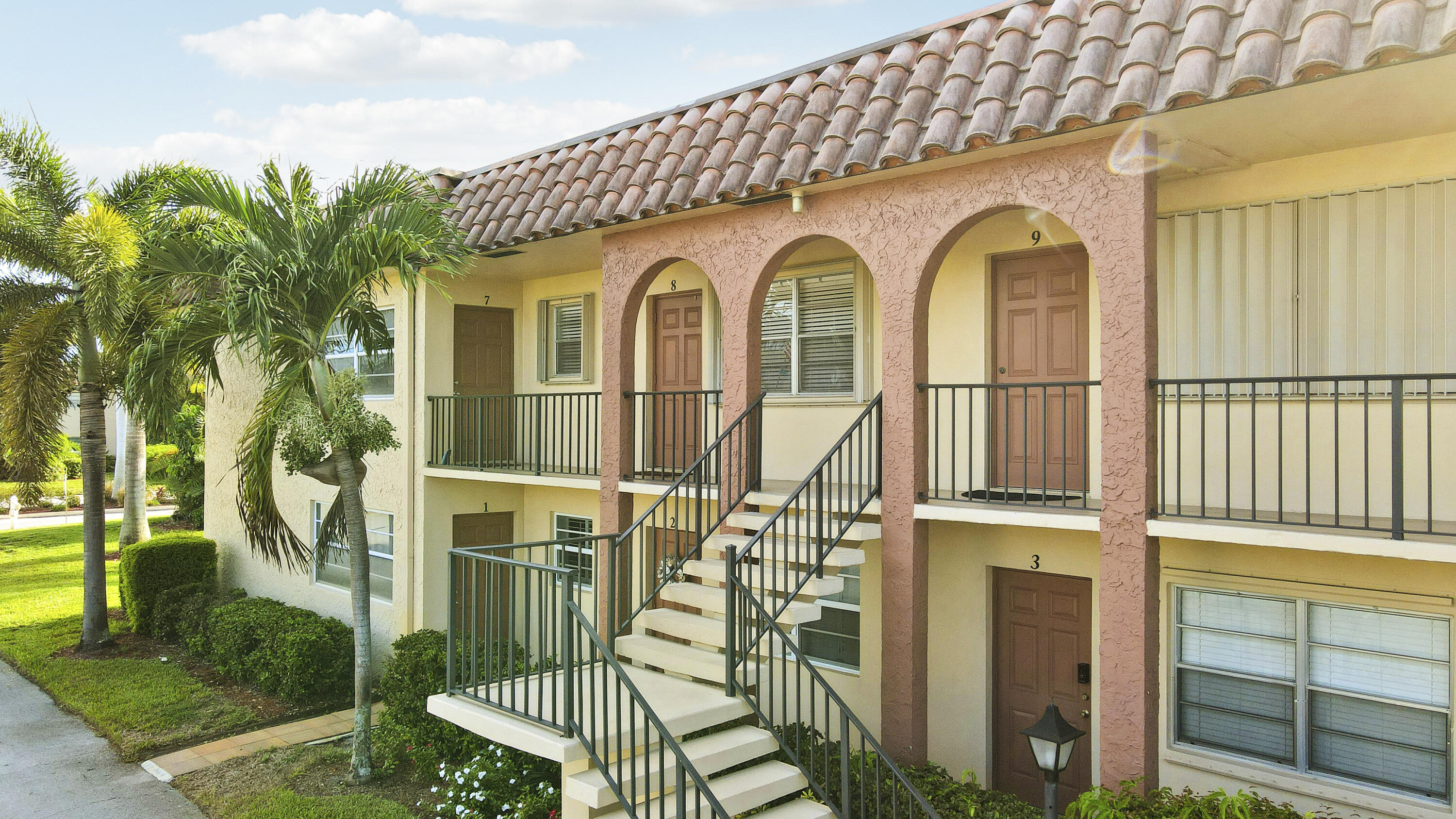 2600 South Kanner Highway, Unit Q8 Stuart, FL 34994 - Photo 3 of 52 a view of a white house with large windows and a table and chairs