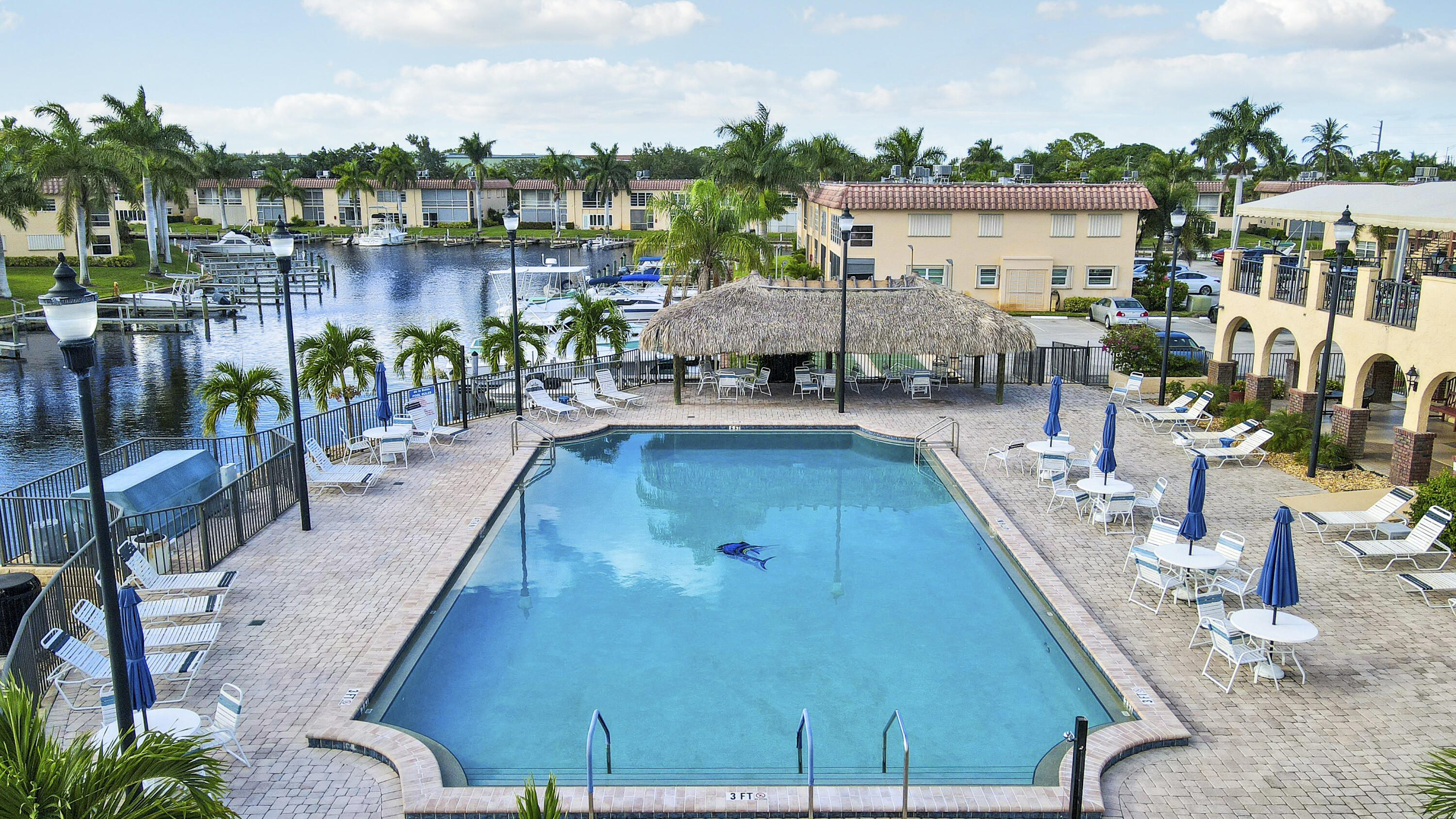 2600 South Kanner Highway, Unit Q8 Stuart, FL 34994 - Photo 34 of 52 an aerial view of a house with swimming pool outdoor seating and lake