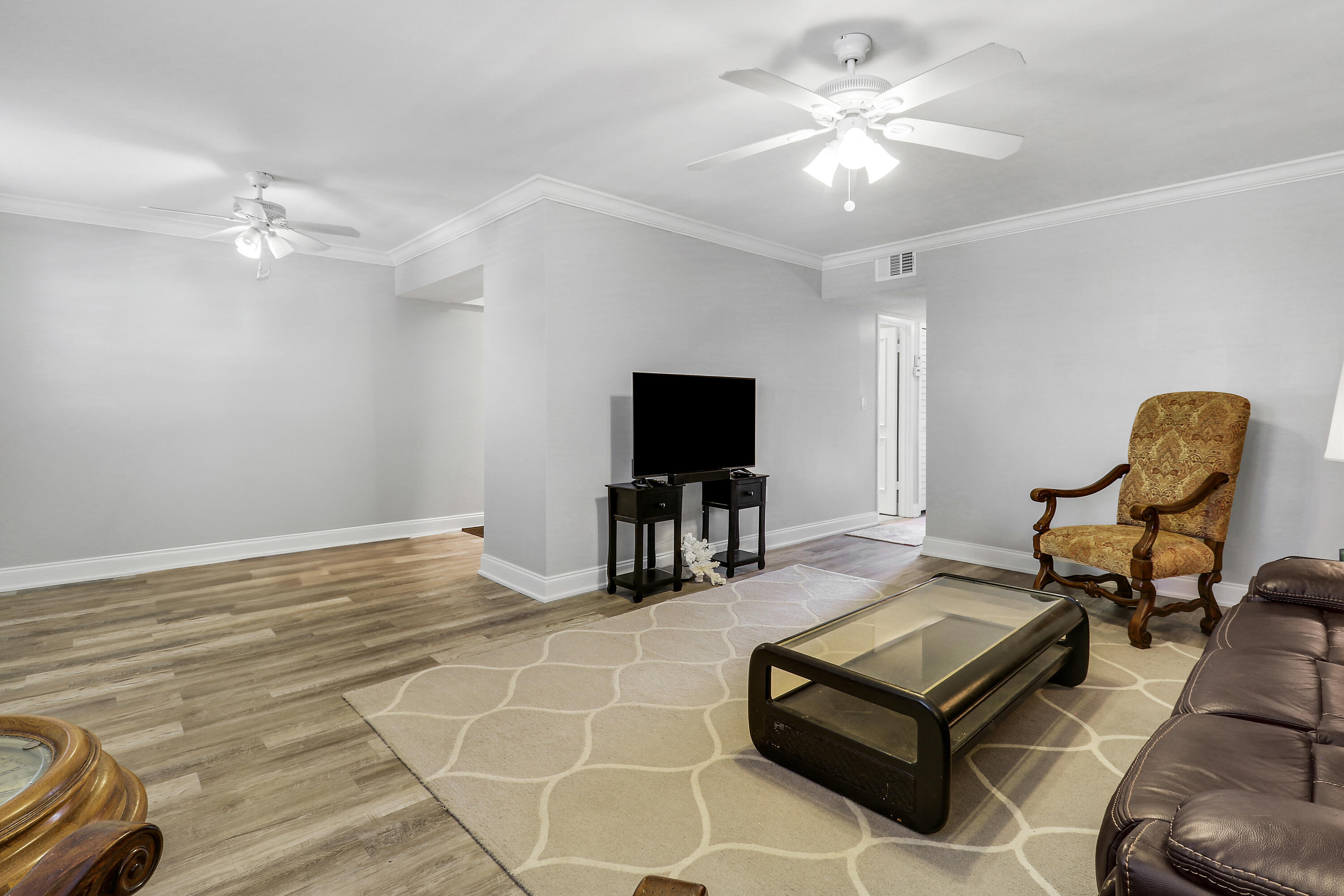 2600 South Kanner Highway, Unit Q8 Stuart, FL 34994 - Photo 7 of 52 a living room with furniture and a flat screen tv with kitchen view