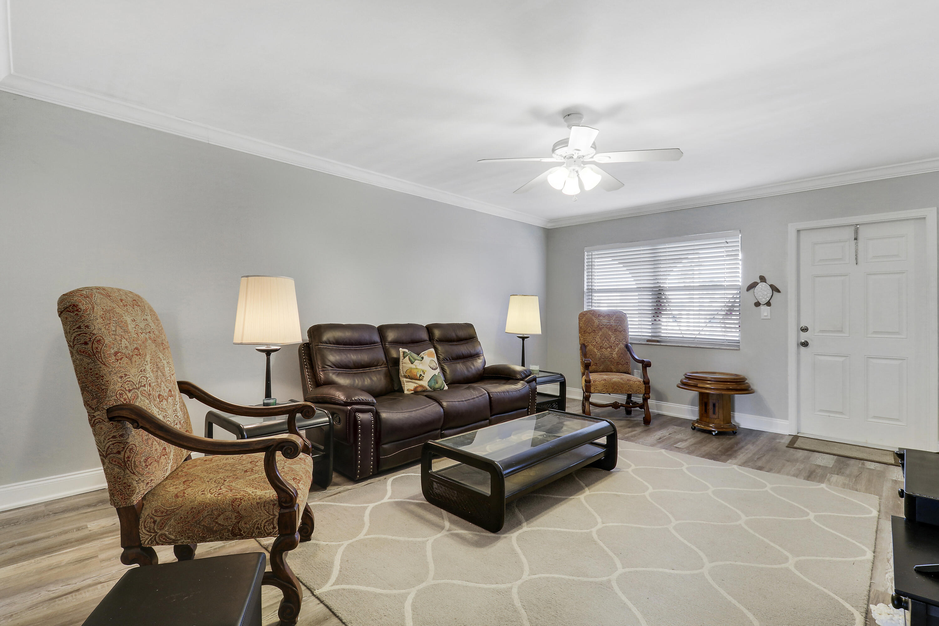 2600 South Kanner Highway, Unit Q8 Stuart, FL 34994 - Photo 9 of 52 a living room with furniture and a lamp