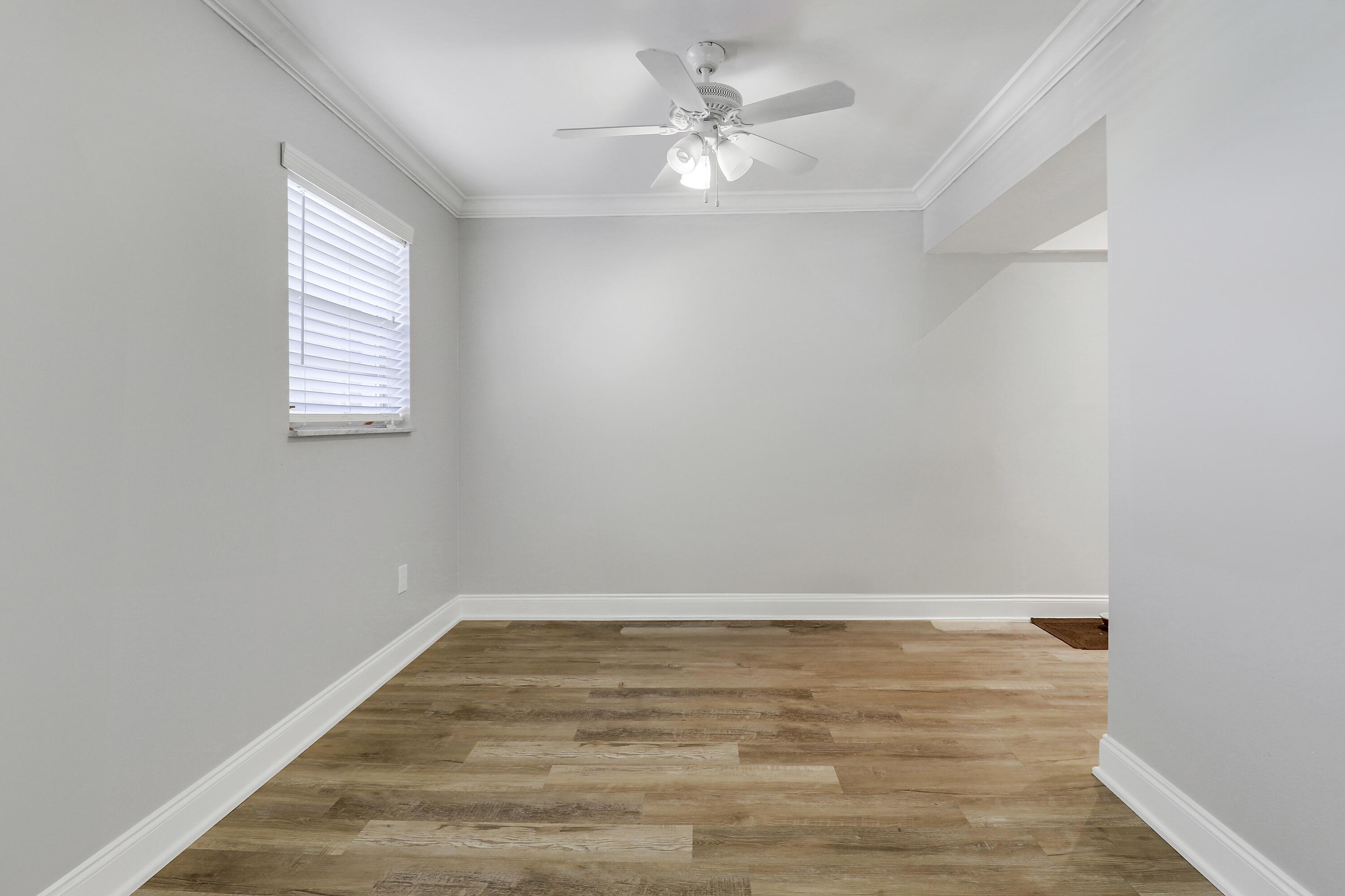2600 South Kanner Highway, Unit Q8 Stuart, FL 34994 - Photo 10 of 52 an empty room with a window and a ceiling fan
