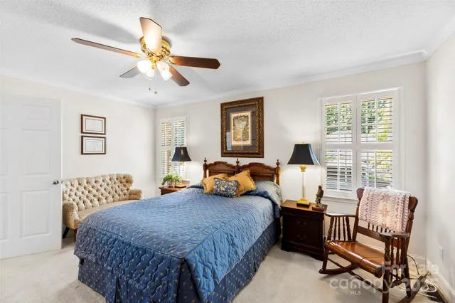 a bedroom with a bed a couch and dresser