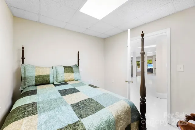 a bedroom with a bed and a mirror