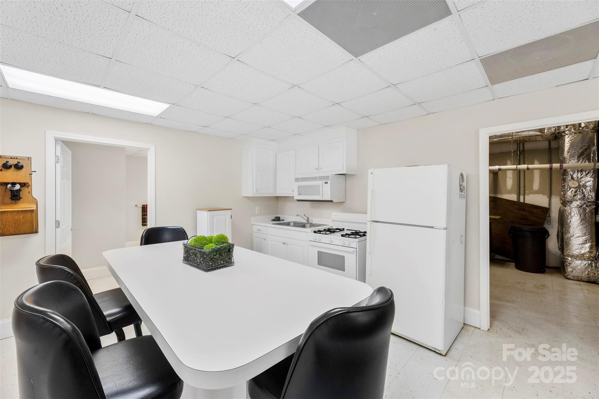 600 Queens Road Cherryville, NC 28021 - Photo 32 of 45 a kitchen with stainless steel appliances a table chairs and a refrigerator