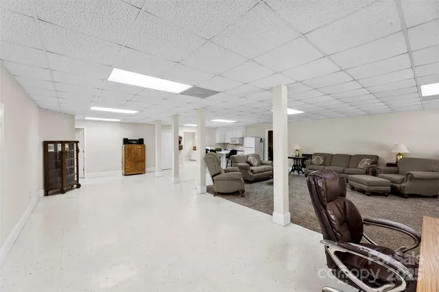 a living room with furniture a couch and a flat screen tv