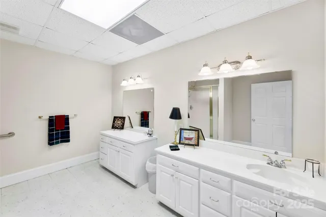 a bathroom with a double vanity sink and mirror